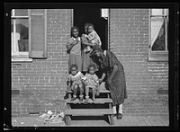 Youngsters in doorway of alley dwelling. Washington, D.C.. Sourced from the Library of Congress.