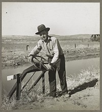 Opening gate leading from Rio Grande, conserving canal in order to irrigate field. Dona Ana County, New Mexico. Sourced from the Library of Congress.