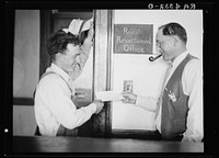Farmer receiving check from county supervisor. Alliance, Nebraska. Sourced from the Library of Congress.