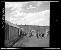After a hard day's work these Resettlement Administration workers welcome the sound of the dinner gong. Rimrock Camp, Madras, Oregon. Sourced from the Library of Congress.