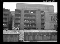 Rear of apartment house showing new Milwaukee courthouse in background. Wisconsin. Sourced from the Library of Congress.
