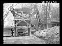 Rock crusher crushing rock to be placed on trails on Pere Marquette recreational project. Grafton, Illinois. Sourced from the Library of Congress.