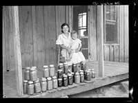 Rehabilitation client and food canned at the suggestion of Resettlement Administration rehabilitation supervisor. Near Batesville, Arkansas. Sourced from the Library of Congress.