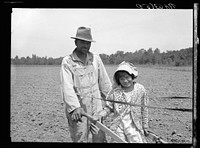 R.E. Sneed, rehabilitation client and eight year old daughter on cotton cultivator. Near Batesville, Arkansas. Sourced from the Library of Congress.