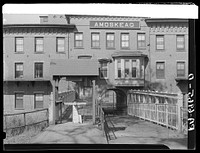 One of the employees' entrances on Canal Street of the Amoskeag mills. Manchester, New Hampshire. Sourced from the Library of Congress.
