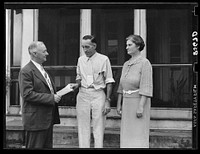 Presenting L.H. Adams with check for five thousand dollars. Adams was the first farmer in Region I to receive a loan under the tenant purchase program. Burlington, New Jersey. Sourced from the Library of Congress.