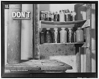 This is a poor place to keep canned foods. The jars are too near the stove. Sourced from the Library of Congress.