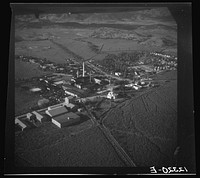 Air view of sugar refinery surrounded by fields. Near Ponce, Puerto Rico. Sourced from the Library of Congress.