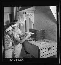 A home economics class of children of resettlers are trained to use the tools which they will work with when they grow up. Note charcoal trough and oven made out of a gasoline can. La Plata project. Puerto Rico. Sourced from the Library of Congress.