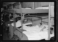 Sleeping quarters for truckmen at Amity Hall, Pennsylvania. An attendant awakens the men at any hour of the day or night required by their schedule. Sourced from the Library of Congress.