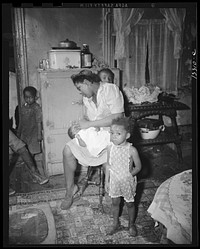 Washington, D.C. A mother getting the children ready for a neighborhood birthday party. Sourced from the Library of Congress.