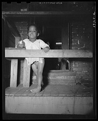 Washington, D.C. Child playing on the front porch of her [i.e. his] home. Sourced from the Library of Congress.