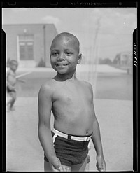 Anacostia, D.C. Frederick Douglass housing project. Cooling off under the community sprayer. Sourced from the Library of Congress.