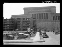 [Untitled photo, possibly related to: Rear of apartment house showing new Milwaukee courthouse in background. Wisconsin]. Sourced from the Library of Congress.