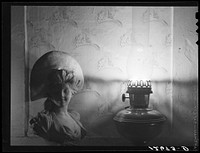 [Untitled photo, possibly related to: Tourist house, Truro. Interior of tourist bedroom. Clothes and half-filled whisky glass belong to tourists. Truro, Massachusetts]. Sourced from the Library of Congress.