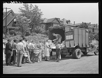 [Untitled photo, possibly related to: Distribution of surplus commodities near the railroad station. Huntingdon, Pennsylvania]. Sourced from the Library of Congress.