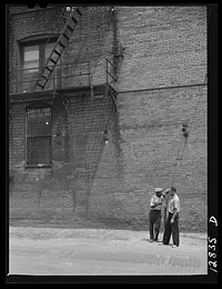 [Untitled negative showing a street scene with two men, Washington, D.C.]. Sourced from the Library of Congress.