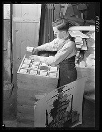 Washington, D.C. Preparing the defense bond sales photomural, to be installed in the Grand Central terminal, New York, in the visual unit of the Farm Security Adnministration. Packing finished print strips for one unit, keyed by code according to the dummy, for future assembly. Sourced from the Library of Congress.
