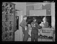 [Untitled photo, possibly related to: Chevy Chase Ice Palace, Washington. D.C. Woman renting or returning skates]. Sourced from the Library of Congress.