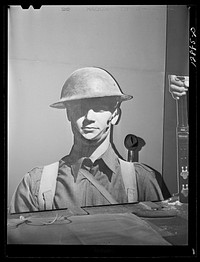 [Untitled photo, possibly related to: New York, New York. Preparing the defense bond sales photomural, designed by the Farm Security Administration, to be installed in the Grand Central terminal, in the shop of a contractor. Cutting out part of a large figure mounted on homosote board with a routing machine]. Sourced from the Library of Congress.