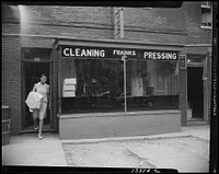 [Untitled photo, possibly related to: Washington, D.C. A tailor in Frank's cleaning and pressing establishment checking over the days intake]. Sourced from the Library of Congress.