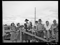 [Untitled photo, possibly related to: Watching a Sunday afternoon baseball game. Tulare migrant camp. Visalia, California]. Sourced from the Library of Congress.