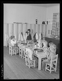 Nursery children eating after nap. Shafter migrant camp. Shafter, California. Sourced from the Library of Congress.