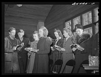 Group singing hymns at the opening of the Sunday school. While there are no churches on the project there are five or six in the area close by. This one is just off the project and is attended by many project members. Dailey, West Virginia. Sourced from the Library of Congress.