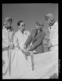 [Untitled photo, possibly related to: Instructor explaining operation of parachute to student pilots. Meacham Field, Fort Worth, Texas]. Sourced from the Library of Congress.