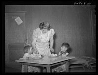 Robstown, Texas. FSA (Farm Security Administration) migratory workers' camp. Migratory worker's wife serving lunch to children in nursery school. Sourced from the Library of Congress.