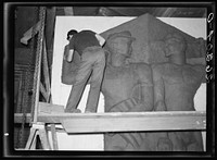 [Untitled photo, possibly related to: Washington, D.C. Vernon Atchely of the Special Skills division of the U.S. Resettlement Administration working on figures modeled in relief for the Greendale school]. Sourced from the Library of Congress.