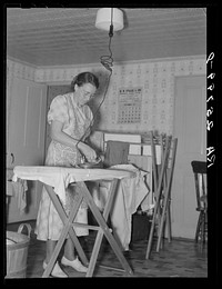 Hired girl ironing. McNally farm, Kirby, Vermont. Sourced from the Library of Congress.