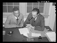 Community manager Walker with applicant. Newport News, Virginia. Sourced from the Library of Congress.