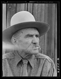 Frank Latta, pioneer cowpuncher, smoking hand-rolled cigarette. Bozeman, Montana. Sourced from the Library of Congress.
