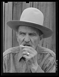 Frank Latta moistening a hand-rolled cigarette. Bozeman, Montana. Sourced from the Library of Congress.