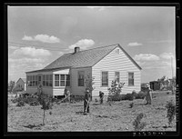 Farmer's wife and children in garden. Fairfield Bench Farms, Montana. Sourced from the Library of Congress.