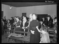 Praying during revival meeting. Pentecostal church, Cambria, Illinois. Sourced from the Library of Congress.