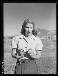 Mrs. Tom Reilly, wife of FSA (Farm Security Administration) rehabilitation borrower, with guinea pigs. Near Hotchkiss, Colorado. Sourced from the Library of Congress.