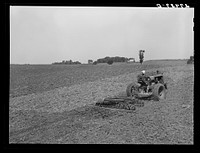 [Untitled photo, possibly related to: Farmer pulling disc and harrow across plowed field. Kimberley farm, Jasper County, Iowa]. Sourced from the Library of Congress.
