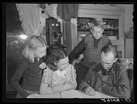 The Dixon family plan their farm program. Since becoming rehabilitation clients they have changed from wheat farming to livestock raising. Saint Charles County, Missouri. Sourced from the Library of Congress.