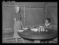 Daughter of evicted sharecropper sets table for dinner. Butler County, Missouri. Sourced from the Library of Congress.