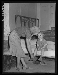 Son of evicted sharecropper is undressed for bed. Butler County, Missouri. Sourced from the Library of Congress.