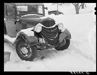 Many farmers blanket their cars and let water out of radiators to prevent freezing in winter. Woodstock, Vermont. Sourced from the Library of Congress.