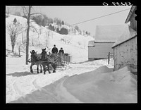 Clinton Gilbert, farmer, and his helper hauling water in milk cans on sled, as their sources of water supply were frozen for two months during very severe winter. Woodstock, Vermont. Sourced from the Library of Congress.