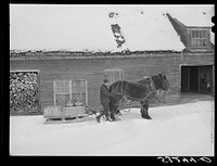 [Untitled photo, possibly related to: Hauling water in milk cans and sled to Putney farm. All other sources of water supply were frozen for two months. Woodstock, Vermont]. Sourced from the Library of Congress.
