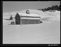 Dairy barn with truckload of hay on farm near Stowe, Vermont. Sourced from the Library of Congress.