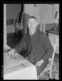 Farmer near Lisbon, New Hampshire, sorting beans for spring planting on rainy day. Sourced from the Library of Congress.