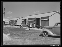Camp members outside their shelter unit at Okeechobee migratory labor camp. Belle Glade, Florida. Sourced from the Library of Congress.