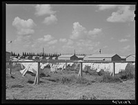 [Untitled photo, possibly related to: Showers for both babies and older children and for parents and complete laundry facilities are provided in the utility building for members of the Okeechobee migratory labor camp. Belle Glade, Florida]. Sourced from the Library of Congress.