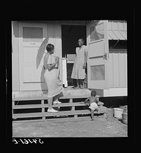 Home management supervisor Corinne Williams visits one of the families in Okeechobee migratory labor camp. Belle Glade, Florida. Sourced from the Library of Congress.